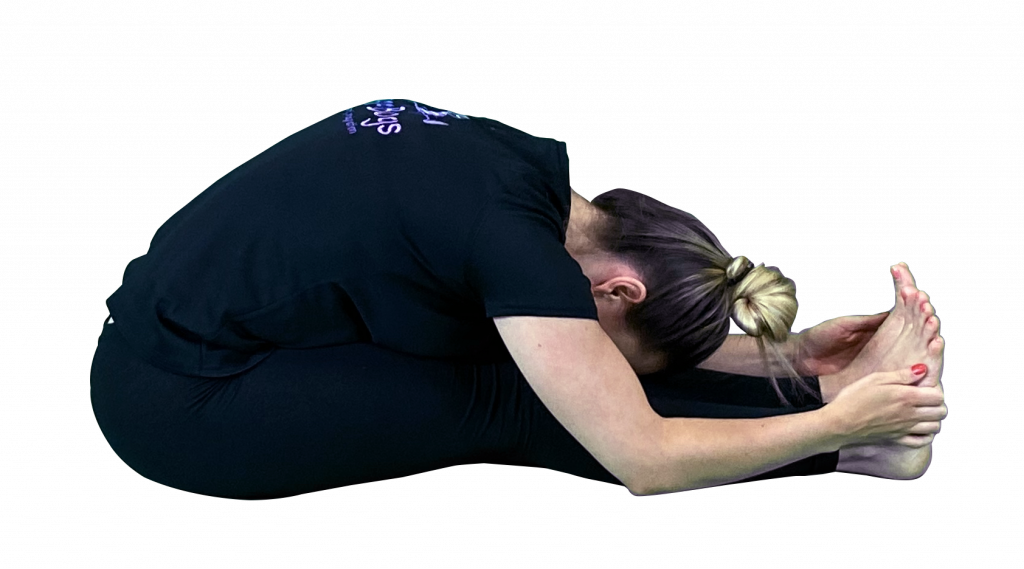 yoga teacher demonstrating forward seated forward bend pose